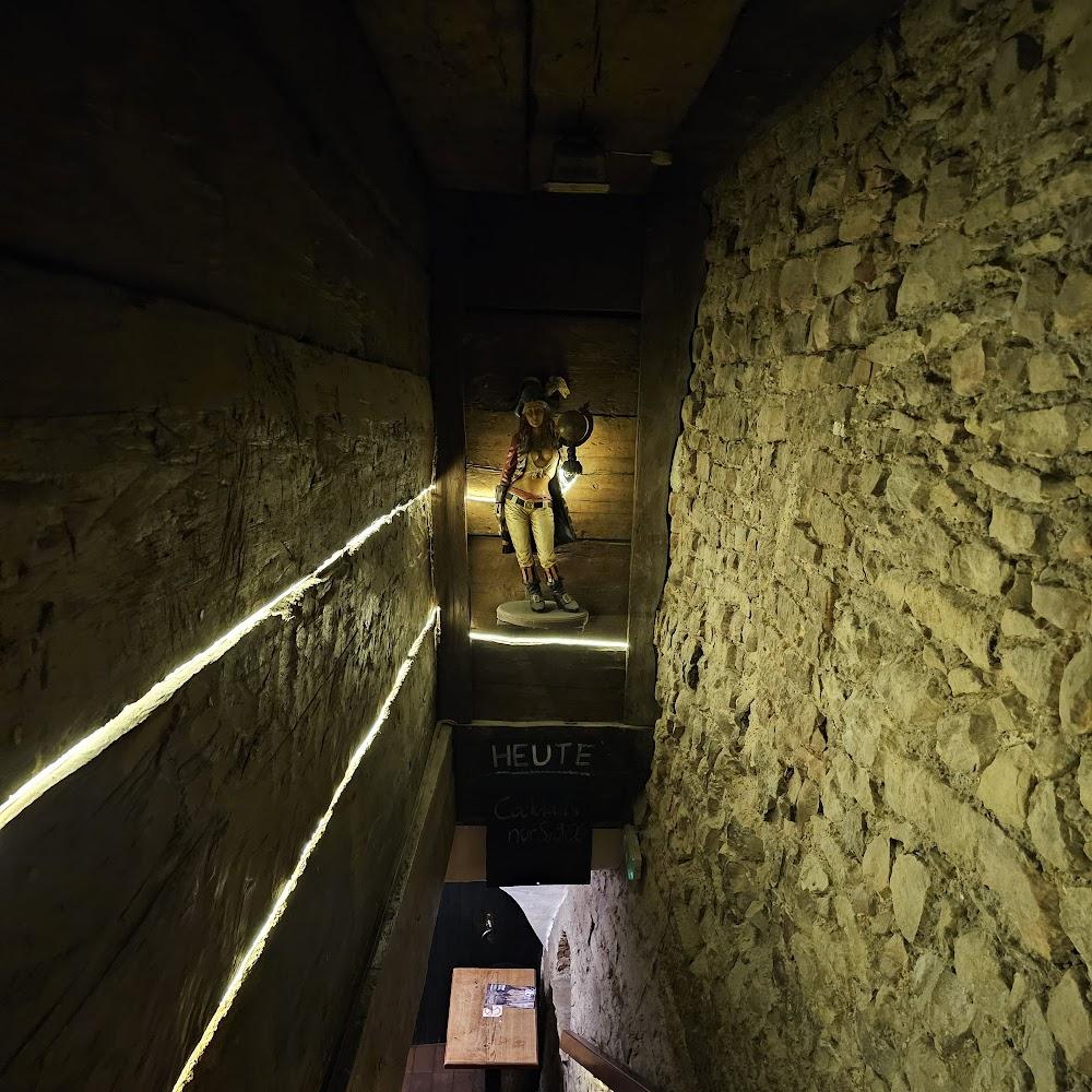 A dark stone staircase with a pirate figurine.